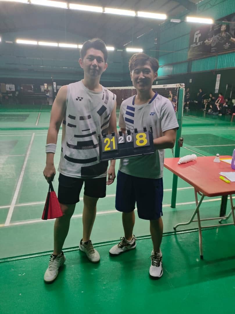 Doubles players on court at the 2024 staff badminton tournament