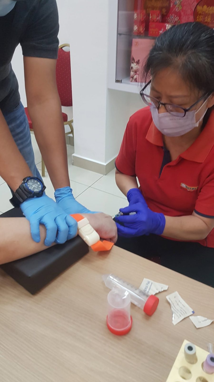 Pathlab nurse carrying out a health screening test on a Yummies Food employee